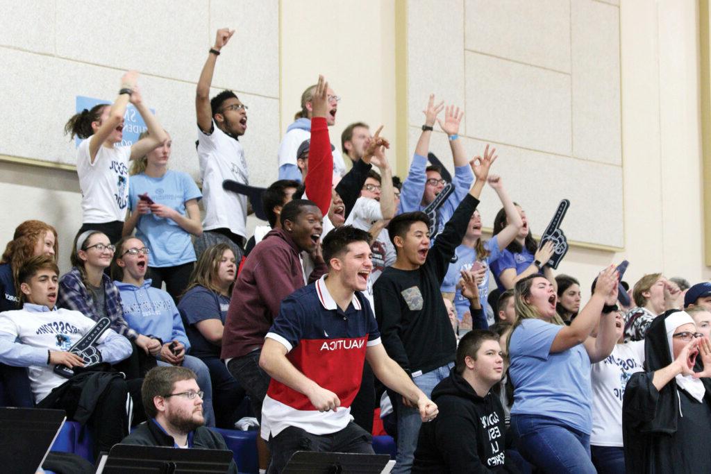 the fan section cheering at a basketball game