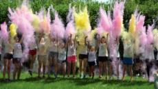students throwing powder in the air during color run